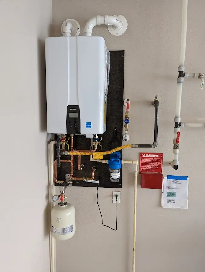 Professional plumber installing copper piping in a Danvers home